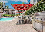 Thumbnail 6 of 39 - Pool lounge area with BBQ grills at Ridgecrest, Lake Forest