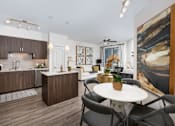 Thumbnail 1 of 39 - A modern kitchen with brown cabinets and a white island.