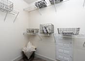 Thumbnail 11 of 39 - A white laundry room with a washer and dryer.