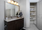 Thumbnail 8 of 39 - A bathroom with a sink, mirror, and cabinet.