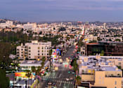 Thumbnail 61 of 117 - A city street with buildings and cars at dusk. at Skyview Sunset, Los Angeles, CA