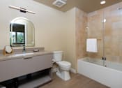 Thumbnail 71 of 117 - A bathroom with a toilet, sink, and bathtub. at Skyview Sunset, Los Angeles, CA, 90046