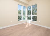 Thumbnail 86 of 117 - A room with a large window and wooden flooring. at Skyview Sunset, Los Angeles, CA, 90046