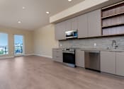 Thumbnail 94 of 117 - A modern kitchen with a stainless steel dishwasher and oven. at Skyview Sunset, Los Angeles, CA