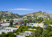 Thumbnail 3 of 117 - A cityscape with buildings and trees under a clear blue sky. at Skyview Sunset, Los Angeles, CA