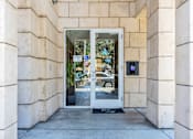 Thumbnail 19 of 40 - the entrance to a building with a glass door