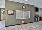 Thumbnail 20 of 40 - a mail room with a filing cabinet and a clock on the wall