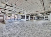 Thumbnail 21 of 40 - an empty parking garage with cars parked in it
