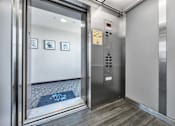 Thumbnail 22 of 40 - an elevator in a building with the door open