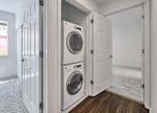 Thumbnail 39 of 40 - a washer and dryer in a laundry room with white doors