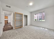 Thumbnail 34 of 40 - an empty living room with a window and a closet