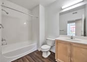 Thumbnail 32 of 40 - a bathroom with a toilet sink and tub and a mirror