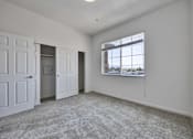 Thumbnail 23 of 40 - an empty living room with white walls and a window
