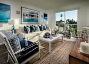 Thumbnail 4 of 25 - A living room with a white sofa and a large window.at Chelsea Santa Monica, Santa Monica, CA  