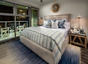 Thumbnail 11 of 25 - A bedroom with a large bed and a ceiling fan.at Chelsea Santa Monica, California  