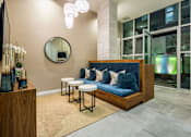 Thumbnail 19 of 25 - A modern living room with a blue couch and a round mirror on the wall.at Chelsea Santa Monica, Santa Monica  