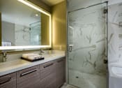 Thumbnail 15 of 25 - A bathroom with a marble patterned shower door.at Chelsea Santa Monica, Santa Monica  