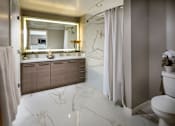 Thumbnail 14 of 25 - A bathroom with a marble floor and a large mirror above the sink.at Chelsea Santa Monica, Santa Monica California  
