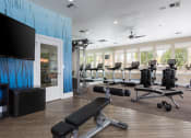 Thumbnail 11 of 36 - Community Fitness Center with Treadmills, Ellipticals, Weights, and TV at Montrachet Apartments, California, 94558