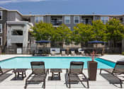 Thumbnail 16 of 36 - Outdoor Pool with Lounge Chairs at Montrachet Apartments, California