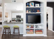 Thumbnail 4 of 36 - Kitchen With Wood-Style Plank Flooring, Breakfast Bar With Quartz Countertop And Bar Stools, GE Stainless Steel Appliances, And Access To Laundry Closet With In-Home Washer And Dryer at Montrachet Apa
