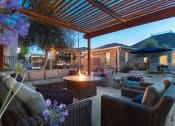 Thumbnail 18 of 36 - Outdoor seating area with fire pit table at Montrachet Apartments, Napa