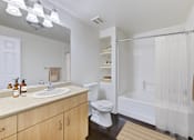 Thumbnail 12 of 19 - A bathroom with a toilet, sink, and shower.