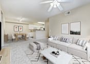 Thumbnail 2 of 19 - A living room with a white couch and a coffee table.