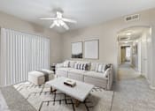 Thumbnail 4 of 19 - A living room with a white couch, a coffee table, and a ceiling fan.