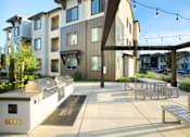 Thumbnail 31 of 87 - A modern building with a white and brown exterior and a walkway in front.