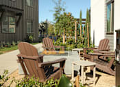 Thumbnail 35 of 87 - A patio with chairs and a fire pit.