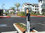 Thumbnail 38 of 87 - A parking lot with a charging station for electric vehicles.