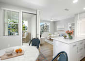 Thumbnail 61 of 87 - A kitchen with a table and chairs in front of a window.