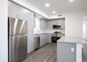 Thumbnail 72 of 87 - A modern kitchen with stainless steel appliances and a center island.