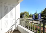 Thumbnail 75 of 87 - A balcony with a metal railing and a white door.
