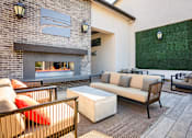 Thumbnail 14 of 85 - A patio with a fireplace and seating area.