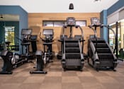 Thumbnail 28 of 85 - A gym with treadmills and elliptical machines.