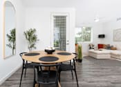Thumbnail 54 of 85 - A modern dining room with a round table and chairs.