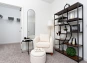 Thumbnail 66 of 85 - A white chair sits in front of a mirror in a room with a shelf.