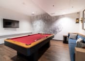 Thumbnail 19 of 50 - a billiards table in a living room with a red pool table at Strata at Mission Bay, California