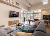 Thumbnail 23 of 50 - a living room with a large gray couch and a fireplace at Strata at Mission Bay, California