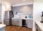 Thumbnail 24 of 50 - a renovated kitchen with stainless steel appliances and white cabinets at Strata at Mission Bay, San Francisco, CA