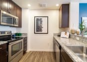 Thumbnail 6 of 50 - a kitchen with granite counter tops and stainless steel appliances at Strata at Mission Bay, California, 94158