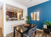 Thumbnail 5 of 50 - a dining room with a blue wall and a table and chairs at Strata at Mission Bay, San Francisco
