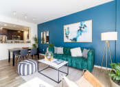 Thumbnail 1 of 50 - a living room with a blue wall and a green couch at Strata at Mission Bay, San Francisco