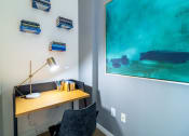 Thumbnail 33 of 50 - a desk with a lamp and a painting on the wall at Strata at Mission Bay, San Francisco