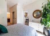 Thumbnail 34 of 50 - a bedroom with a bed and a dresser and a mirror at Strata at Mission Bay, San Francisco, 94158