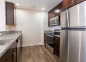 Thumbnail 35 of 50 - a kitchen with stainless steel appliances and marble counter tops at Strata at Mission Bay, San Francisco