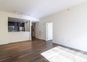 Thumbnail 37 of 50 - an empty living room and kitchen with wood flooring and white walls at Strata at Mission Bay, California