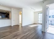 Thumbnail 41 of 50 - an empty living room and kitchen with wood flooring and a window at Strata at Mission Bay, San Francisco, 94158